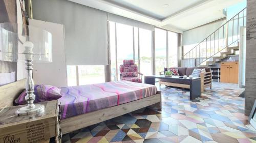 a bedroom with a bed and a table and a staircase at Studio Dbayeh Near Abc Wz Duplex Rooftop, Sea View in Dbayeh
