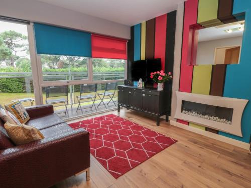 a living room with a couch and a fireplace at Flat 5 Fairwinds in Poole
