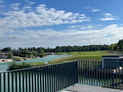 a view from the deck of a resort with a river at Pri jazere - Golf rezort in Hrubá Borša