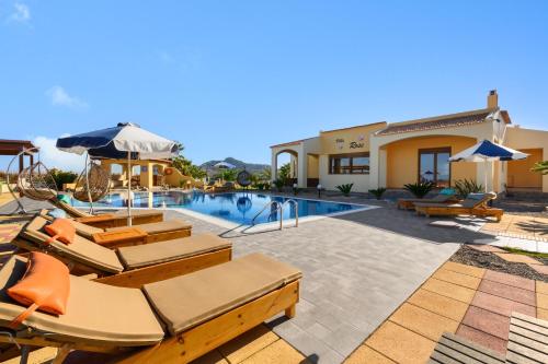 a villa with a swimming pool and patio furniture at Villa Rose in Kolimbia