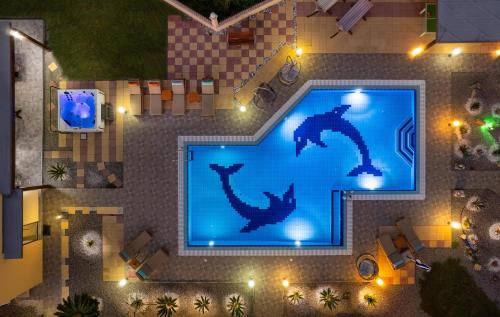 a picture of a swimming pool at night at Villa Rose in Kolimbia