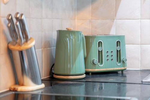 a green toaster sitting on top of a counter at *-* Beautiful Townhouse in Central London *-* in London