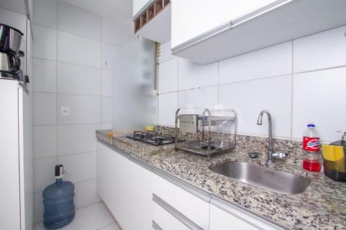 a kitchen with a sink and a counter top at Flat em Porto de Galinhas - Muro Alto Clube in Porto De Galinhas