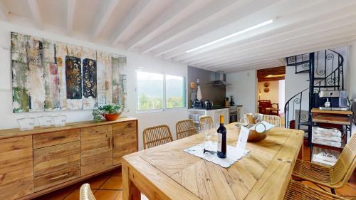 a dining room with a wooden table and chairs at Azores Furnas Quinta Do Vale in Furnas
