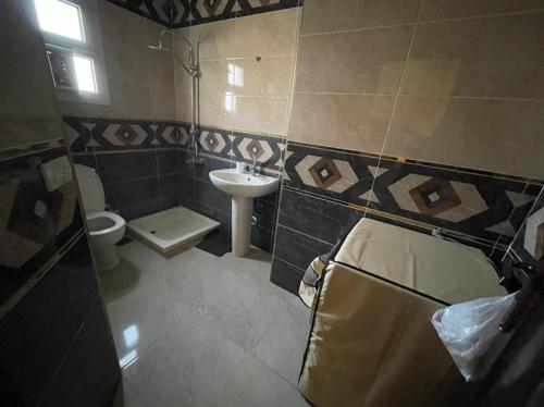 a bathroom with a sink and a toilet and a sink at العين السخنة in Ain Sokhna