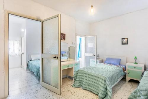 a bedroom with two beds and a mirror at Town House - Private Rooms - Near Sea in Il-Gżira