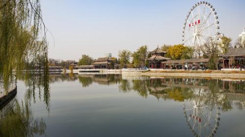 a ferris wheel in a amusement park with a lake at Holiday Inn & Suites Tianjin Downtown by IHG in Tianjin