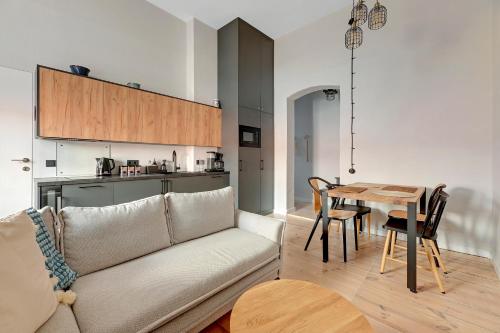a living room with a couch and a table at Azzuro Living - Cozy Two Bedroom Spot by the Beach & Town by Lion Apartments Sopot in Sopot