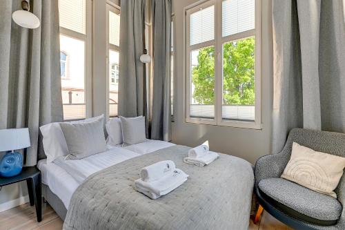 a bedroom with a bed and a couch and a chair at Lion Apartments - Azzuro Premium Loft with 2 Bedr in Sopot