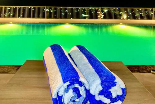a pair of blue and white slippers sitting next to a swimming pool at Starlit Suites Tirupati in Tirupati