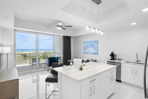 a white kitchen with a view of the ocean at Ocean Club Treasure Island Hotel in St Pete Beach