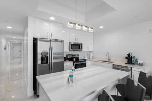 a kitchen with a counter with a bottle of water on it at Ocean Club Treasure Island Hotel in St Pete Beach