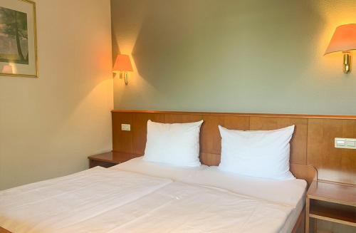 Cama o camas de una habitación en Der Grüne Baum