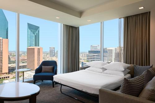 a hotel room with a bed and a large window at JW Marriott Dallas Arts District in Dallas
