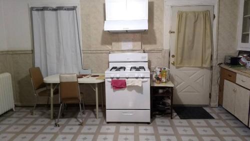 a kitchen with a stove and a table and a door at Non-Smokers Only Private Room 6 with Kitchen Best Price for 1 Long-Term Guest 