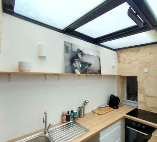 a kitchen with a sink and a window at Modern Flat Historic Center in Bordeaux
