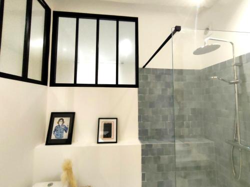 a bathroom with a shower and a glass shower stall at Modern Flat Historic Center in Bordeaux