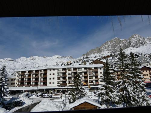 a hotel with snow covered mountains in the background at Hotel Nievesol in Formigal