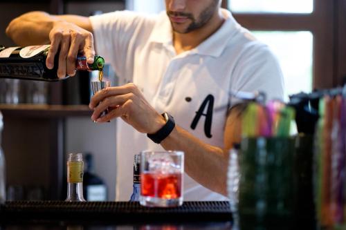 a man is making a drink in a bar at ALEGRIA Palacio Mojacar - Adults Only in Mojácar