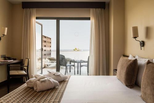 a bedroom with a bed with a view of the ocean at ALEGRIA Palacio Mojacar - Adults Only in Mojácar