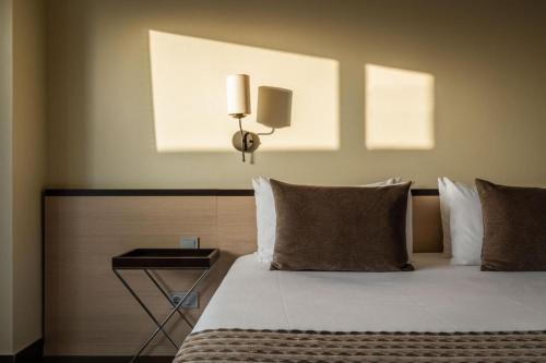 a bedroom with a bed with a night stand next to it at ALEGRIA Palacio Mojacar - Adults Only in Mojácar