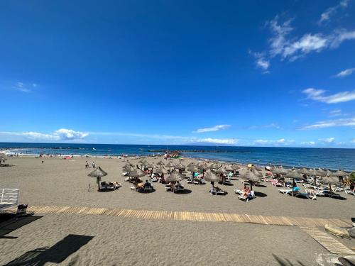 a group of people sitting on the beach at Casa Sami in Playa de las Americas