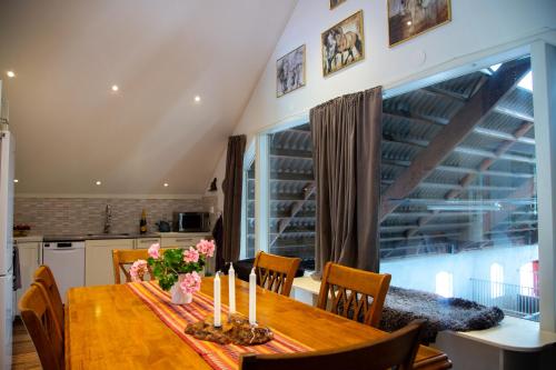 a dining room with a table with candles on it at Ängagården - Gårdslyckan in Våxtorp