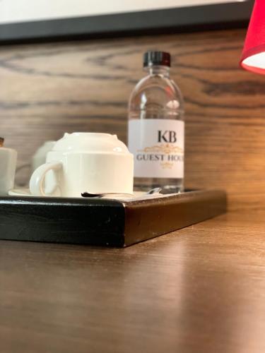 a bottle of water and a cup on a table at KB Guesthouse in Groblersdal