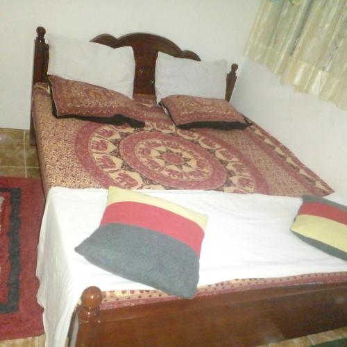 a bedroom with a bed with white sheets and pillows at Grace Villa Bentota in Bentota