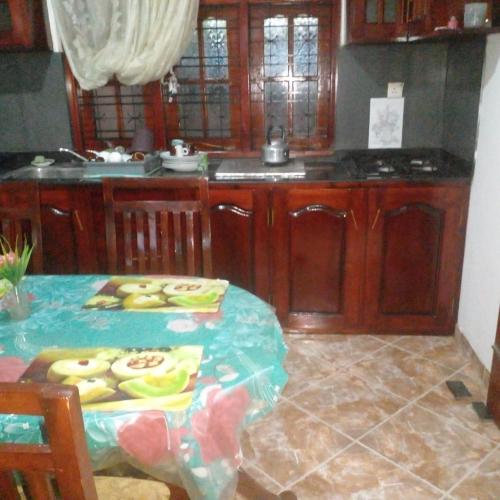 a kitchen with a table and a kitchenasteryasteryasteryasteryasteryasteryasteryastery at Grace Villa Bentota in Bentota
