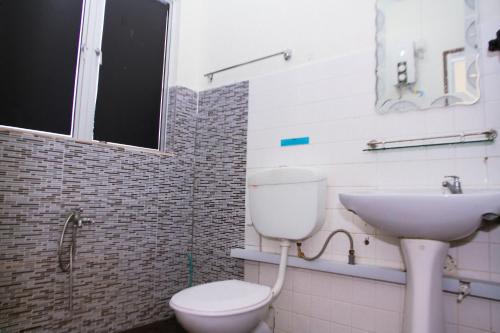 La salle de bains est pourvue de toilettes et d'un lavabo. dans l'établissement Myra Hotel Mersing, à Mersing