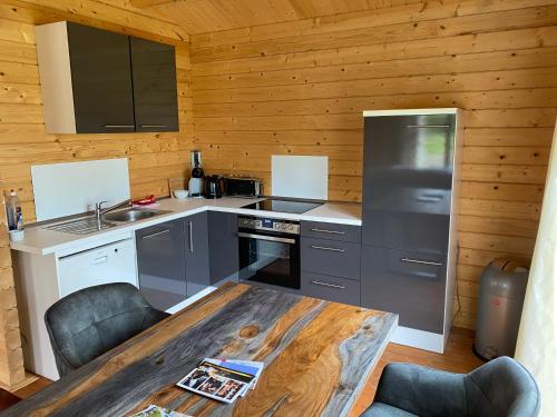 a kitchen with a wooden cabin with a wooden table at Ferienhäuser Altes Land in Jork