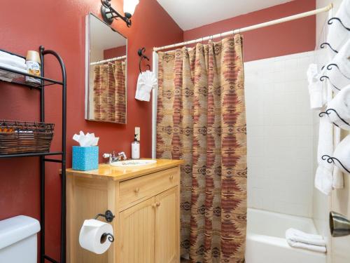 a bathroom with a shower curtain and a sink at Rio Vista Casita in Santa Fe