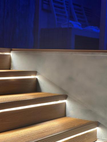 a set of wooden stairs with lights on them at Hotel Masaniello Luxury in Casoria