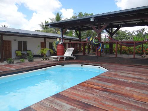 a swimming pool on the deck of a house at Sutopia Holiday Resort in Meerzorg