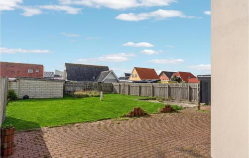 a view of a yard with houses and a fence at Lovely Home In Thyborøn With Kitchen in Thyborøn