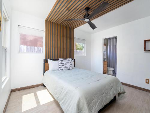 a bedroom with a bed with a ceiling fan at Return House in Santa Fe