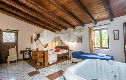 a bedroom with a bed and a bath tub at Cozy Home In Arenella With Outdoor Swimming Pool in Arenella