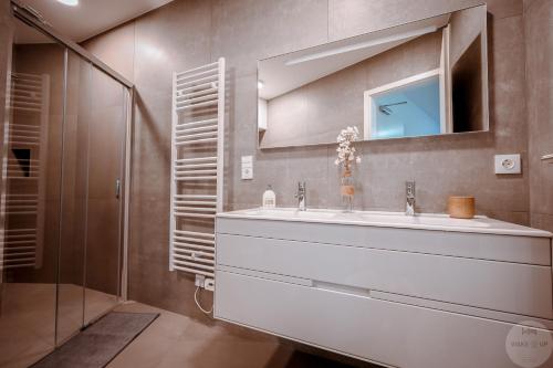a bathroom with a sink and a mirror at WakeUp Lux-City 