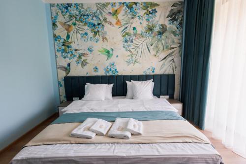 a bedroom with a bed with two towels on it at Dream Hotel in Haghpat