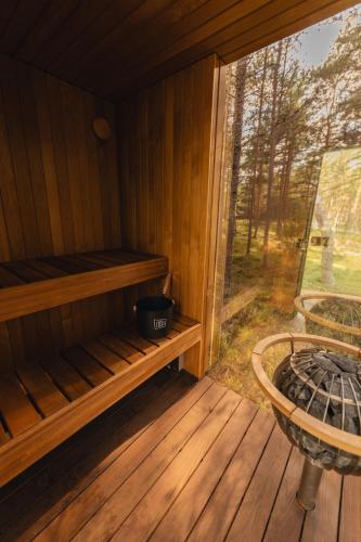 an inside of a sauna with a large window at ÖÖD Hötels Lohusalu LEIDA & ENNO in Laulasmaa