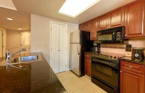 a kitchen with a sink and a stove top oven at Enticing Huge Unit at Cancun Resort Strip Las Vegas in Las Vegas