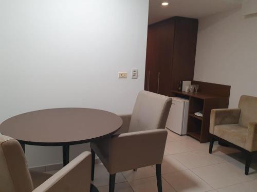 a dining room with a table and chairs at Flat Beach Class Internacional in Recife