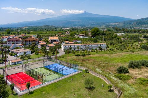 an aerial view of a tennis court in a city at Villaggio Alkantara in Giardini Naxos