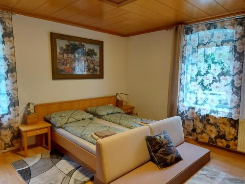 um pequeno quarto com uma cama e um sofá em Mariazell Salza Haus em Gusswerk