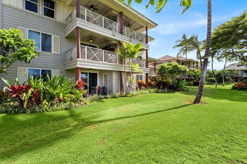 a house with a lawn in front of it at Waikoloa Beach Villas L3 in Waikoloa