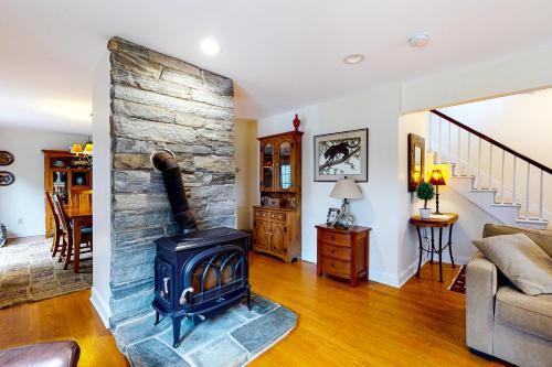 a living room with a wood stove in it at Harbor House in Camden