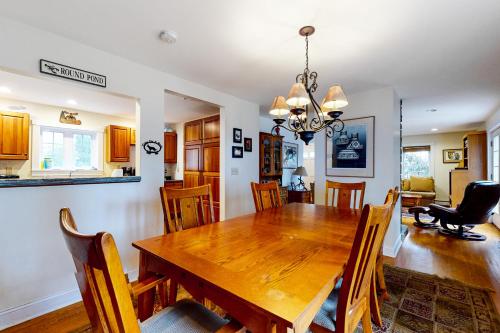 a dining room and living room with a wooden table and chairs at Harbor House in Camden