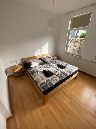 a bedroom with a bed and a large window at Apartment in guter Lage für bis zu 5 Personen in Oldenburg
