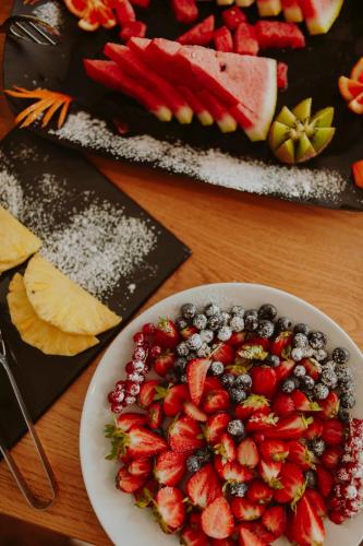 a plate of strawberries and blueberries on a table at Hotel Limone in Limone sul Garda